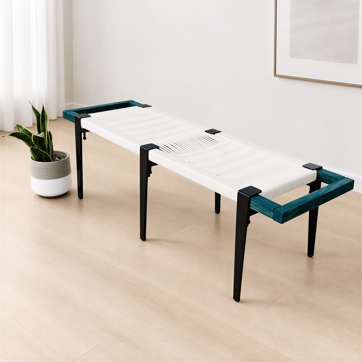 a modern bench with a white seat and black metal legs, placed on a wooden floor next to a potted plant.