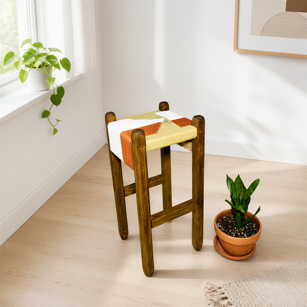 a wooden stool with a colorful cushion, placed on a wooden floor next to a potted plant.