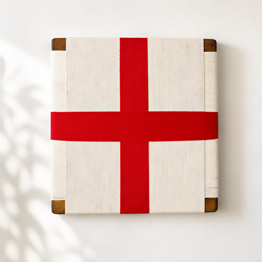 A square-shaped object with a red ribbon tied around it, placed against a white background.