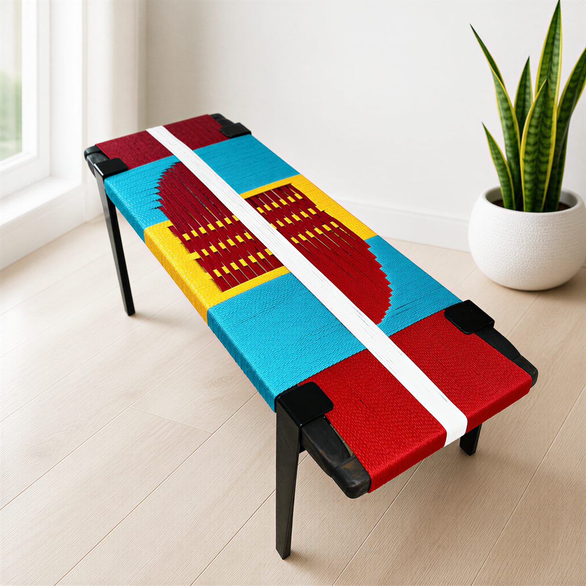 a colorful bench with a vibrant design on its seat, placed in a room with a potted plant nearby.