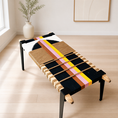 a modern, colorful bench with a unique design, placed on a wooden floor in a room with a white wall and a framed picture.