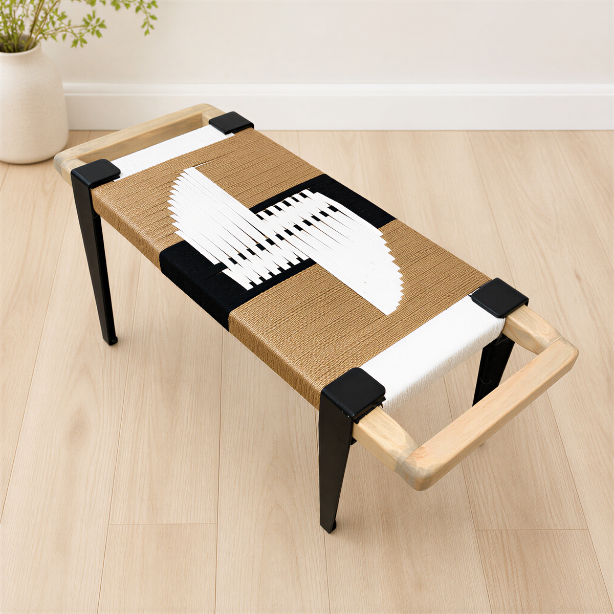 a modern, wooden bench with a woven seat and black metal legs. The bench has a unique design with a black and white geometric pattern on the seat and legs.
