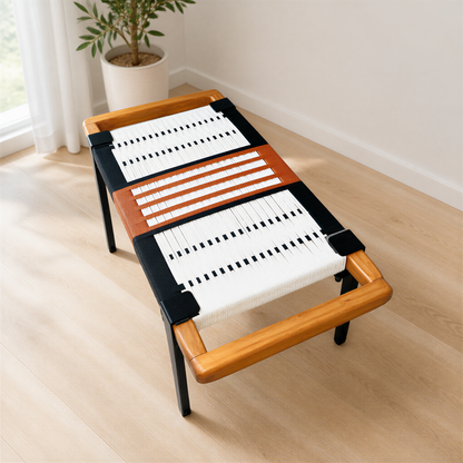 a modern, wooden bench with a woven seat and a black and white striped pattern on the backrest. The bench is placed on a wooden floor, and there is a potted plant nearby.