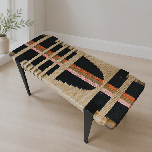 a modern, woven bench with a black and orange color scheme, placed on a wooden floor in a room with a window.