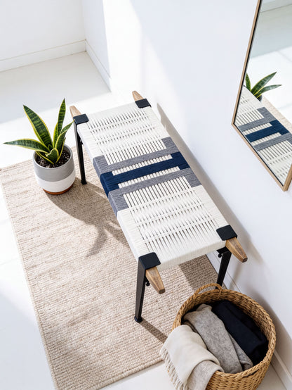 a modern, minimalist living space with a woven bench, a potted plant, and a woven basket.