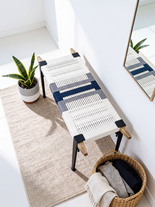 a modern, minimalist living space with a woven bench, a potted plant, and a woven basket.