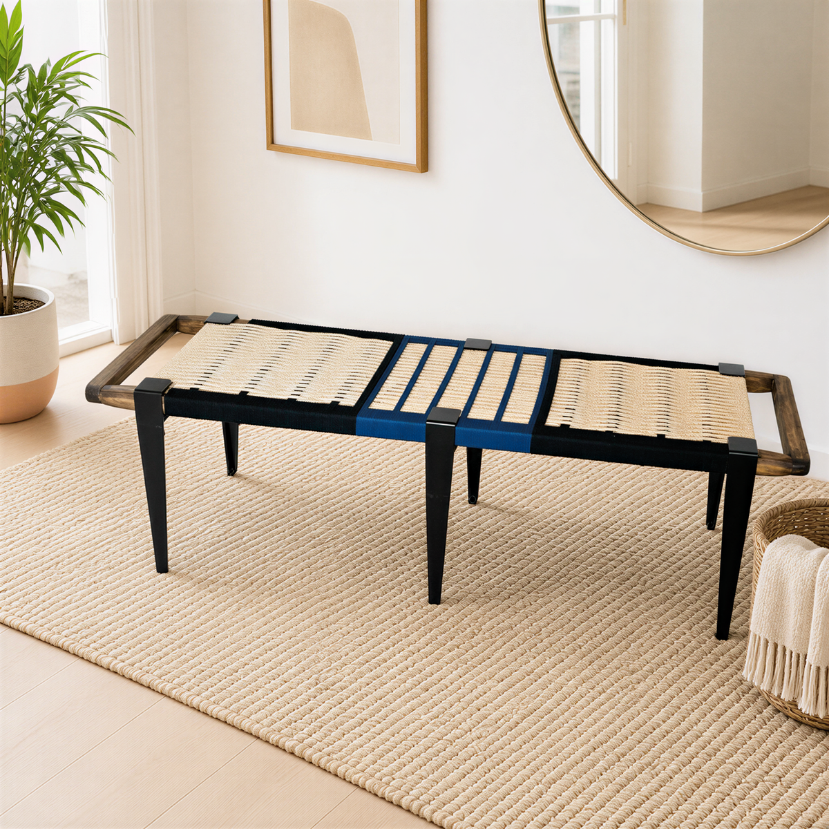 a modern black bench with woven seat and legs, placed on a beige rug in a room with a large mirror and a plant.