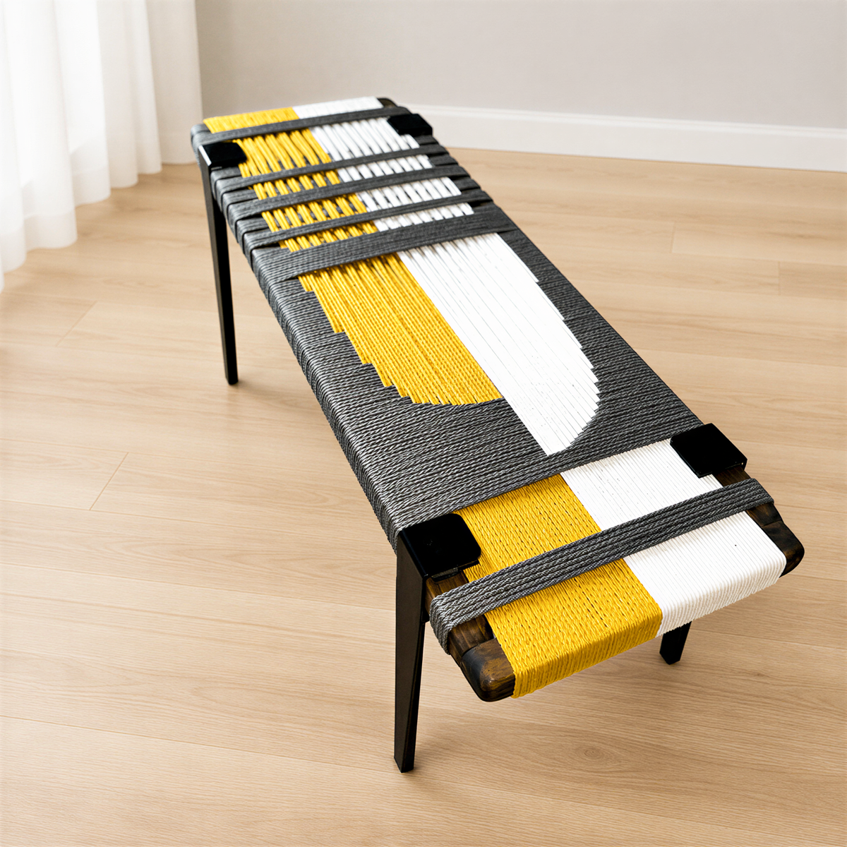 a modern bench with a unique design, featuring a combination of black, yellow, and white colors. The bench is placed on a wooden floor, and it appears to be a piece of furniture that could be used as a seating area or a decorative element in a room.